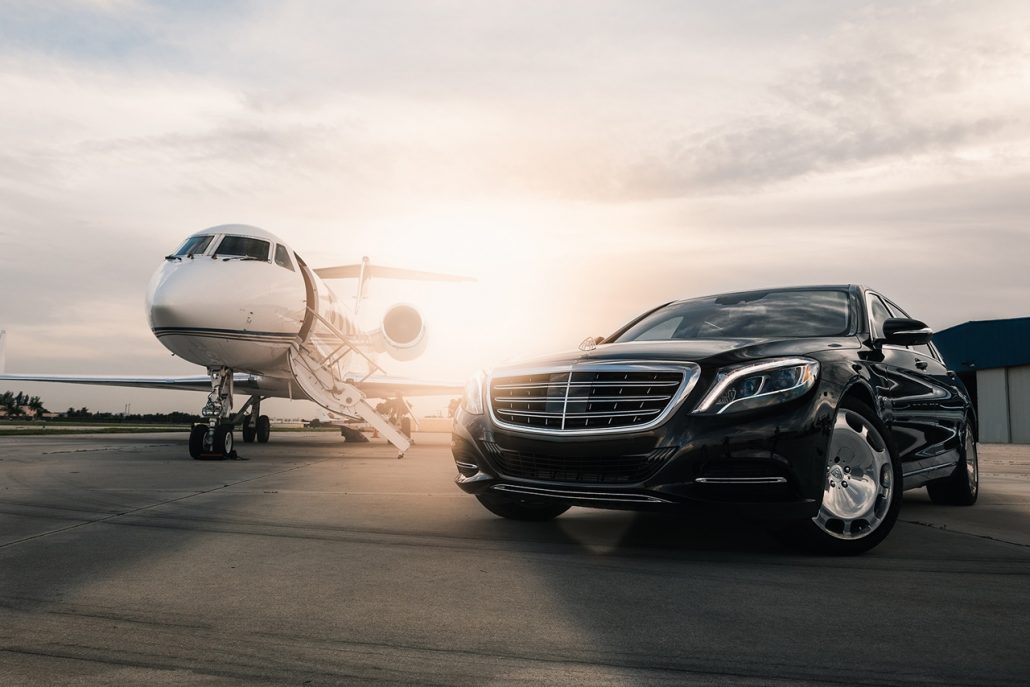 Global logistics — private jet and car at dusk